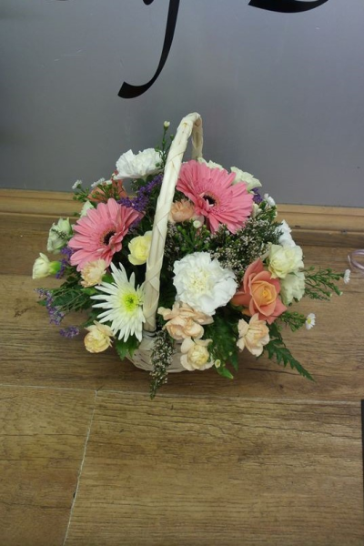 Basket of Dreams - Beautiful basket arrangement in a mix of flours and colours. Flowers in colours of pastel pinks, purple, creams with greenery.