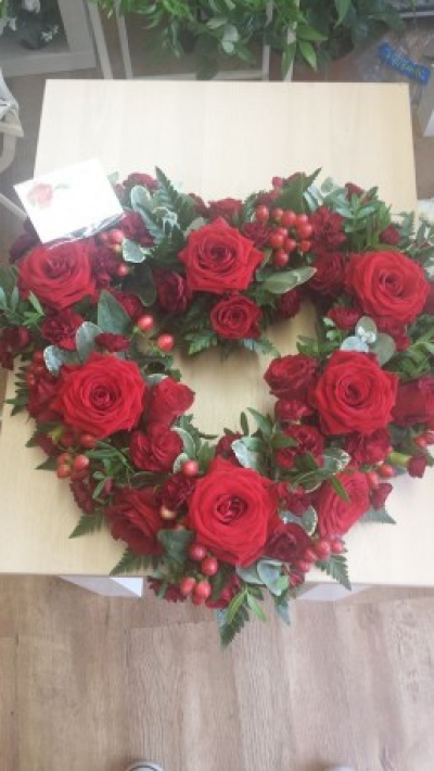 Open Heart - standard size 56 cm x 56 cm .Open heart with roses, spray roses,hypericum berries and mixed foliage .

Flowers and colours can be changed to suit your requirements
